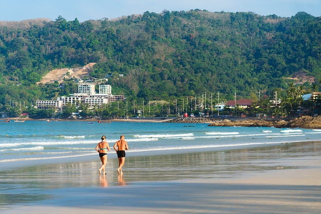 Expats running on beach